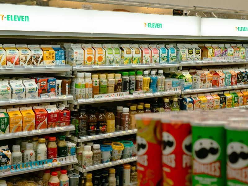 Shelves of snacks and drinks inside a 7-eleven.